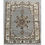 A Persian Balouch woollen handmade rug with central medallion within a foliate border on a beige