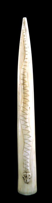 An early 20th century African ivory pipe head carved in relief with a snake, possibly Luango,