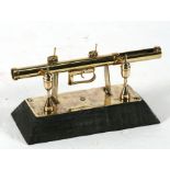 A trench art desk stand in the form of an anti-tank bazooka, 19cms (7.5ins) wide.