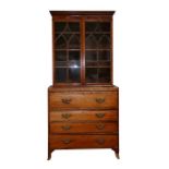 A Regency mahogany secretaire bookcase, the pair of glazed doors enclosing a shelved interior