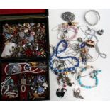 A quantity of costume jewellery in a black jewellery box