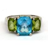 A 14ct white gold topaz and peridot ring. Approx UK size N