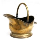 A brass coal scuttle.