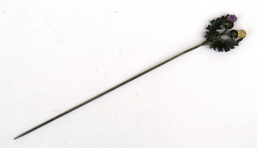 An Edwardian silver twin thistle hat pin.