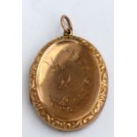 A Victorian yellow metal oval locket engraved with birds and flowers. 3.5cm (1.3 ins) high