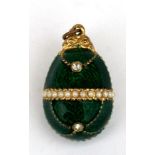 A green enamel egg shaped pendant. 3cm (3.2 ins) high