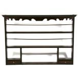 A Georgian style oak wall mounted plate rack, stamped 'Gott, Pickering', 135cms (53ins) wide.