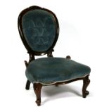 A Victorian walnut button back nursing chair.