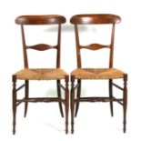 A pair of Regency chairs with strung seat on turned legs