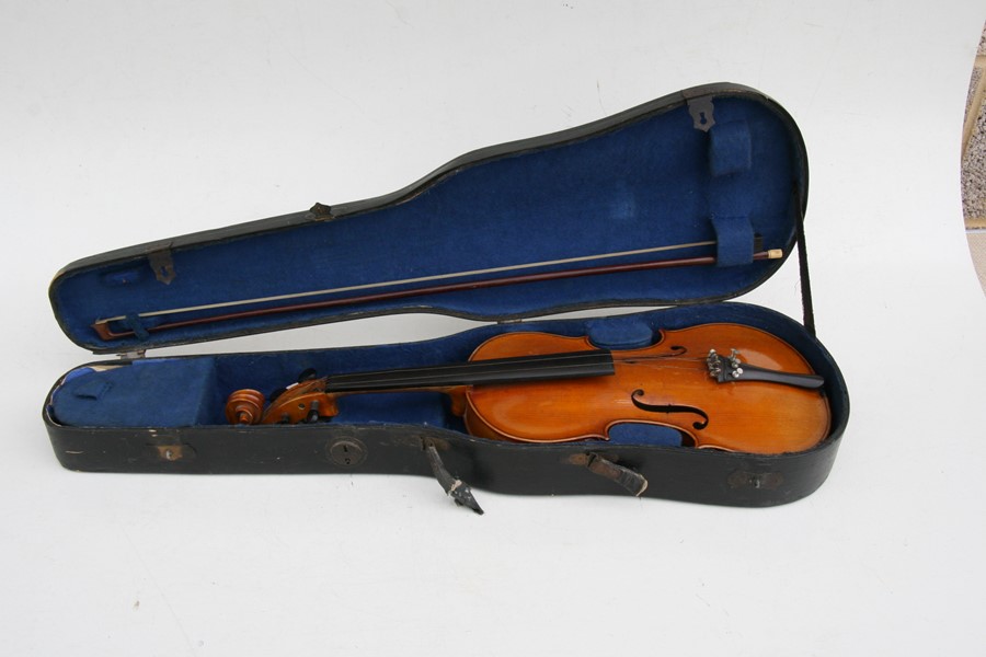 A one-piece backed violin and bow, the back 35.5cms (14ins) long, in a pine carry case.