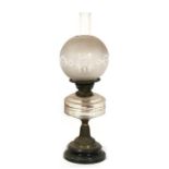 A large Victorian brass oil lamp with glass chimney and shade, 56cms (22ins) high.