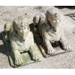 A pair of reconstituted stone sphinx figures. 43cm (17 ins) long
