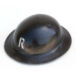 A WWII black painted home front Rescue Party helmet with liner.