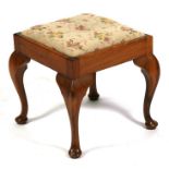 A walnut stool with needlework seat on cabriole legs