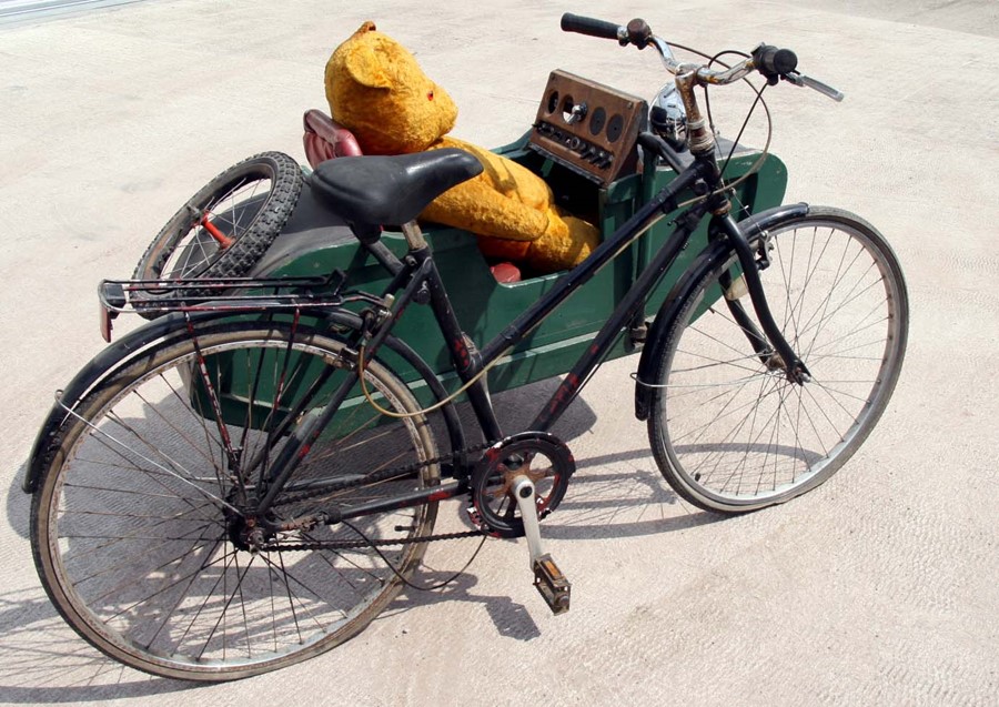 A vintage Raleigh pedal bike and wooden side-car.