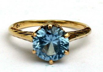 A 10ct gold ring set with a single topaz. Approx UK size L