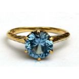A 10ct gold ring set with a single topaz. Approx UK size L