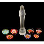 A group of seven glass millefiori paperweights together with a frosted glass figure of the