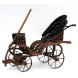 A rattan dolls buggy. 69cm ( 26 ins) long