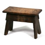 An Arts & Crafts oak stool. 46cm (18 ins) wide