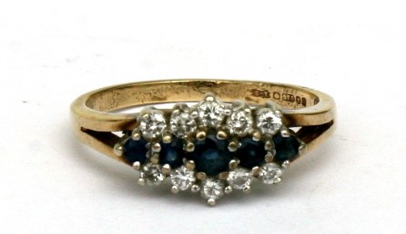 A 9ct gold sapphire and white stone ring. Approx UK size L