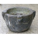 An early large stone mortar, 33cms (13ins) diameter.
