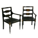 A pair of Regency style ebonised and painted carver chairs.