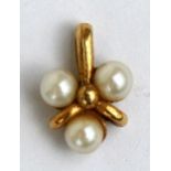 A 9ct gold pendant set with three pearls