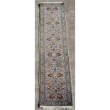 A Persian Isfahan handmade woollen runner with repeat foliate design on a cream ground, 384 by 77cms