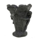 An Art Nouveau lead vase decorated in relief a naked maiden amongst lilies with a Green Man mask,