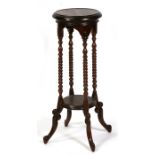 A mahogany plant stand on barley twist supports. 28cm (11 ins) diameter