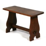 An Arts & Craft oak stool. 61cm (24 ins) wide