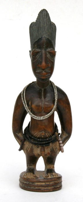 African/tribal art. A Nigerian Yoruba male Ibeji twin figure with glass and coconut shell beads. .