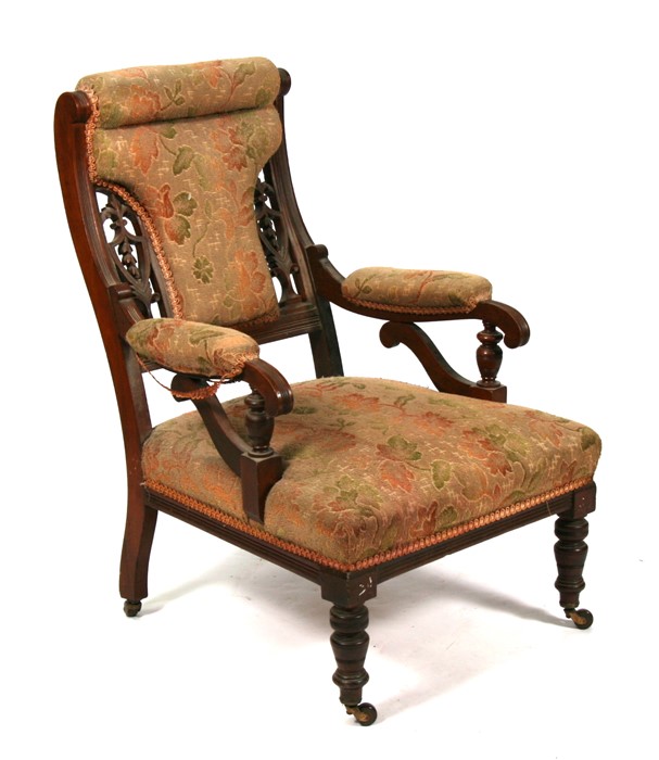 A Victorian upholstered walnut arm chair