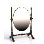 An oak oval dressing table mirror. 37cm (14.5 ins) wide