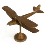 A brass model of a WW1 two seater Biplane with spinning propeller mounted on a brass base.