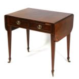 A 19th century drop-flap library table with two frieze drawers opposed by two faux drawers, on