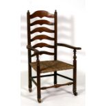 An early 19th Century ladder back chair with rush seat