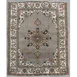 A Persian Balouch woollen handmade rug with central medallion within a foliate border on a beige