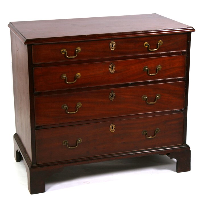 A Georgian mahogany chest with two short and three graduated long drawers standing on bracket