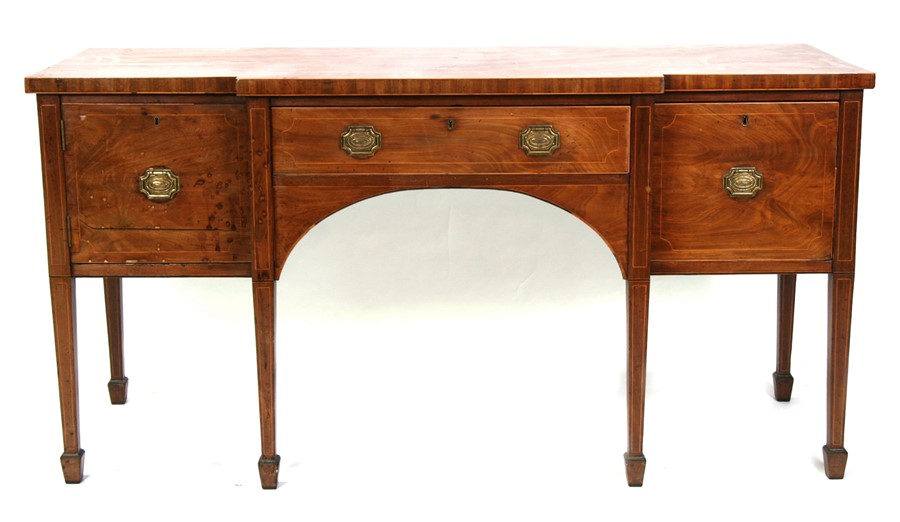 A Georgian mahogany breakfront sideboard with central frieze drawer flanked by a pair of cupboards