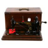 A cased Singer sewing machine.