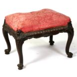 A George III mahogany stool on carved cabriole legs (possibly Irish), 67cms (26.5ins) wide.
