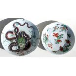 A Chinese famille verte charger decorated with a scrolling dragon holding a flaming pearl, 39cms (