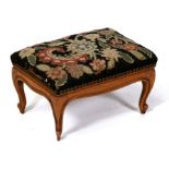 A French walnut footstool on cabriole legs, 33cms (13ins) wide.
