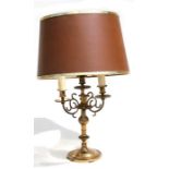 A brass three-arm table lamp.