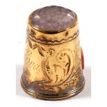 A 14ct gold sewing thimble with engraved decoration.