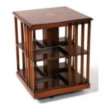 A reproduction yew wood revolving bookcase, 50cms (19.5ins) wide.