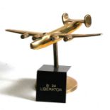 A brass model of the WW2 American heavy bomber the Consolidated B-24 Liberator mounted on its