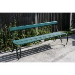 A green painted metal garden bench, 168cms (66ins) wide.